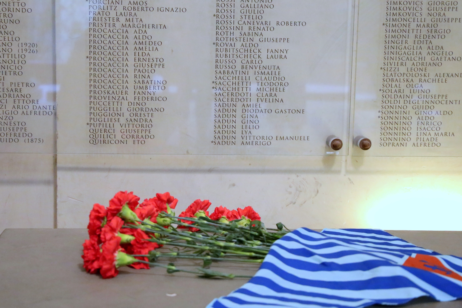 Fiori davanti alla targa che ricorda, nella Galleria delle Carrozze, le vittime della deportazione (foto di Antonello Serino, Ufficio Stampa - Redazione di Met)